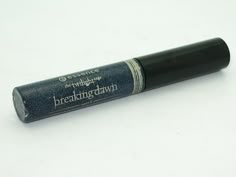 a close up of a black lip balck on a white surface with the words breaking dawn printed on it