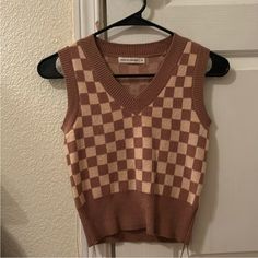 Nwot Size Small Brown And Tan Checkered Super Soft Tags Removed But Never Worn Beige Urban Outfitters Tops For Fall, Urban Outfitters Beige Tops For Fall, Retro Urban Outfitters Tops For Fall, Urban Outfitters Brown Sleeveless Top, Sleeveless Brown Top From Urban Outfitters, Checkered Sweater Vest, Checker Vest, Sweaters Brown, Checkered Sweater