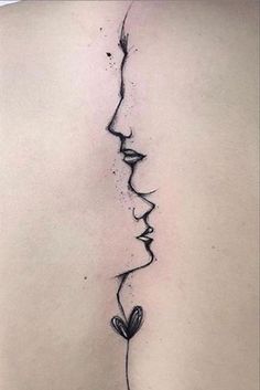 the back of a woman's neck with a line drawing of two faces on it