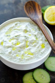 cucumber and lemon dip in a bowl with wooden spoon