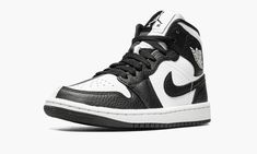 The Women’s Air Jordan 1 Mid “Split Black and White” is a women’s-exclusive colorway with a mismatched design.  As its name implies, the “Split Black and White” Jordan 1 Mid features a split appearance that inverses the shoe’s black-and-white color block on each side.  The lateral side of the shoe features a white tumbled leather base with contrasting black leather overlays and Swoosh branding.  The medial side reverses the color block, with a black leather base with white leather overlays and S Jordan 1 Mid Split, Womens Air Jordan 1, Black And White Jordans, Black White Jordans, Womens Air Jordan, Air Jordan 1 Women, Latest Jordans, Black White Shoes, Sporty Shoes