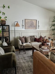 a living room filled with lots of furniture next to a wall mounted plant on top of a wooden shelf