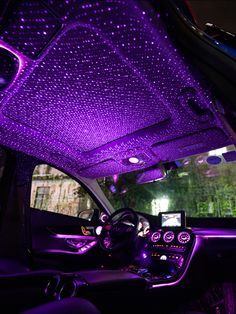 the interior of a car with purple lights