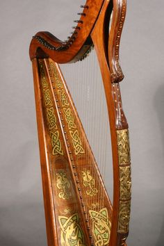 an old wooden harp with intricate designs on it