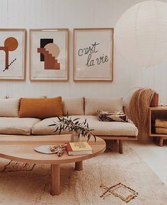 a living room filled with furniture and pictures on the wall above it's coffee table