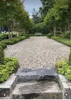 a stone walkway surrounded by trees and bushes