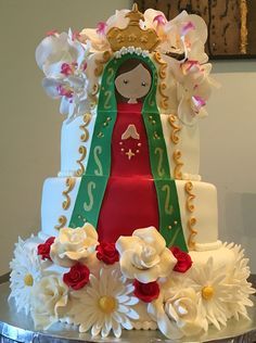 a cake decorated with flowers and a doll on top