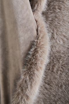 an up close shot of the fur on a coat that has been draped over it