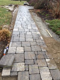 a brick walkway is being built in the yard