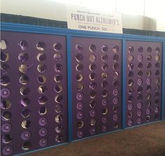 there is a purple wall with many circles on it and a sign that says punch out aller's