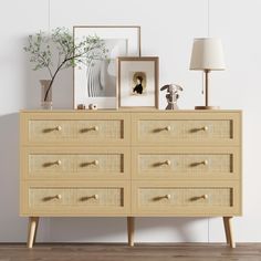 an image of a dresser with pictures on the top and lamps on the bottom side