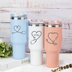 three personalized tumblers with hearts and scissors on them