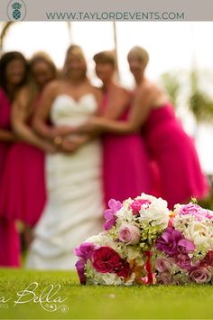 a bunch of women standing in front of each other with flowers on the ground next to them