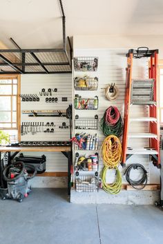 a garage filled with lots of different types of tools and equipment on the wall next to each other