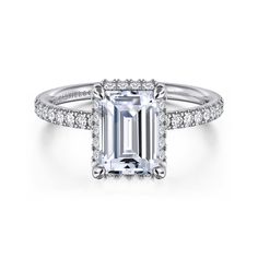 an emerald cut engagement ring with diamond shoulders