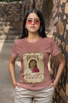 "Introducing our \"Brown Baddie\" Graphic T-shirt - a stunning fusion of South Asian culture and boho artistic flair that celebrates the strength and beauty of South Asian women. Pair it with your favorite jeans, skirts, or shorts for a casual day out, or dress it up with accessories for a chic boho-inspired ensemble. This tee effortlessly transitions from everyday wear to a fashion statement. Searching for the perfect gift for a South Asian friend or loved one? Look no further! This \"Brown Bad Brown Bohemian Crew Neck T-shirt, Bohemian Brown Crew Neck T-shirt, Brown Cotton T-shirt, Fashion Illustrations Techniques, Favorite Jeans, Girls Tshirts, Leisure Wear, Asian Beauty, Boho Chic