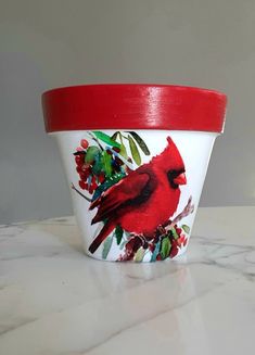 a cup with a cardinal painted on it