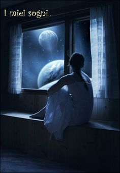 a woman sitting on a window sill looking out at the moon and planets outside