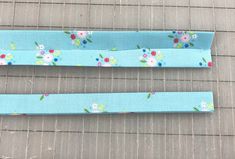 two pieces of blue fabric with flowers on them