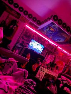 a living room filled with lots of furniture and neon lights on the ceiling above it