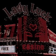 a casino sign lit up at night with the words lady luck written in large letters