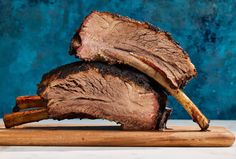 two slices of roast beef on a cutting board