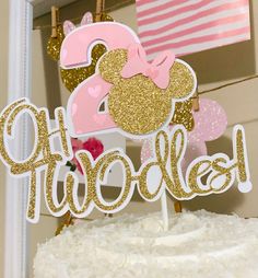 a minnie mouse cake topper with the number two on it