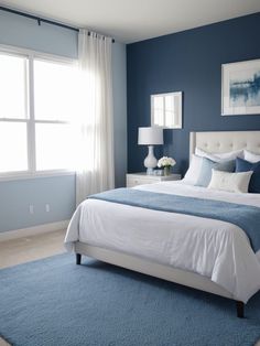 a bedroom with blue walls and white furniture