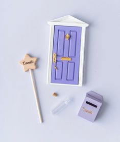 a purple door with a wooden star next to it and some other items on the table