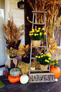 a porch decorated for fall with pumpkins, hay and flowers