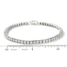 Illuminate her wrist with the lavish look of this 3/4 ct. t.w. diamond sterling silver tennis bracelet. Fashioned in sterling silver Round diamonds - each in a settings that enhance size and radiance - create this sparkling line. Captivating with 3/4 ct. t.w. of diamonds This 7.0-inch bracelet secures with a lobster claw clasp. Luxury Sterling Silver Tennis Bracelet With Diamond Accents, White Gold Tennis Bracelet With Diamond Accents, Sterling Silver Diamond Bracelet With Pave Setting For Anniversary, Silver Diamond Bracelet With Pave Setting, Sterling Silver Bracelet With Pave Diamond Setting, Classic Cubic Zirconia Diamond Bracelet With Pave Setting, Classic Cubic Zirconia Bracelet With Pave Setting, Fine Jewelry Silver Tennis Bracelet With Diamond Accents, Timeless Tennis Bracelet With Pave Setting In Cubic Zirconia