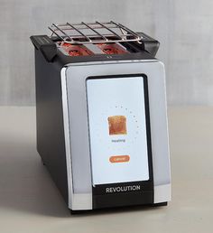 a toaster with the word revolution on it and four slices of bread in front of it