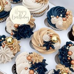 cupcakes decorated with blue and gold decorations