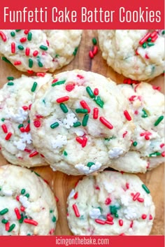 cookies with sprinkles and white frosting on a wooden cutting board that says funfetti cake batter cookies