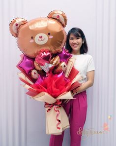 a woman standing next to a giant teddy bear bouquet