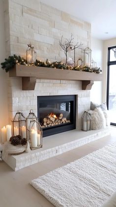 a fireplace with candles and christmas decorations on it