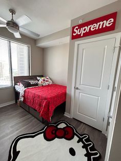 a bedroom with a hello kitty rug on the floor and a bed in the corner