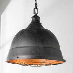 an industrial style pendant light hanging from a ceiling fixture in a kitchen or dining room