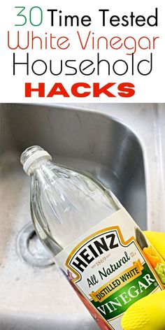 a bottle of vinegar sitting on top of a sink