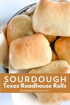 a bowl filled with rolls sitting on top of a table