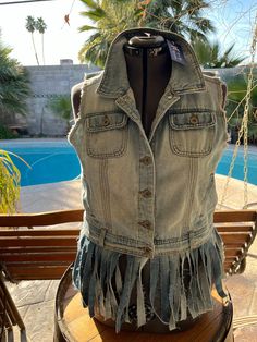 Denim vest for women. This retro classic jean vest with ecru lace and jean fringe for casual, daily wear, work or festivals. Made of upcycled sturdy denim fabric, washed blue color is a classic. Hand wash is advised. Crafted by hand with re-purposed material that I find in thrift and consignment stores. Every piece is washed with Diva laundry soap before it's assembled. I love design and give New Life to the garments that need a new home. I image the person who will wear it and love it! Bohemian Denim Jacket With Frayed Hem, Bohemian Cotton Denim Jacket With Frayed Hem, Light Wash Denim Vest With Frayed Hem For Summer, Light Wash Cotton Denim Vest With Frayed Hem, Casual Cotton Vest With Frayed Hem, Summer Distressed Cotton Denim Vest, Light Wash Denim Vest With Frayed Hem, Distressed Medium Wash Denim Vest For Summer, Spring Acid Wash Cotton Denim Vest