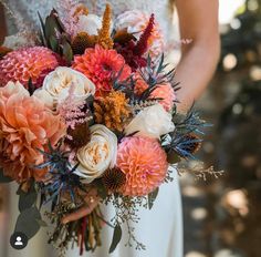 a bride holding a bouquet of flowers in her hands