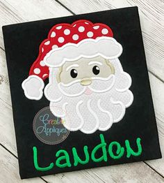 a black square with a santa clause on it and the word laughin'appliques written in green