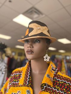 This African Print Fedora is beautiful and unisex. The fedora looks great for the summer with a touch of cowrie shell. Comfortable fits small to med size heads.Don't delay order yours today. Traditional Wide Brim Fedora For Summer, Traditional Flat Brim Fedora For Summer, Traditional Wide Brim Summer Fedora, Traditional Summer Fedora With Flat Brim, Artisan Fitted Hat For The Beach, Traditional Short Brim Fedora For Beach, Unique Fedora With Short Brim For The Beach, Unique Brimmed Fedora For Beach, Unique Handmade Fedora For The Beach