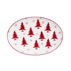 a red and white plate with snowflakes on the rim, decorated with christmas trees