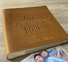 a personalized leather book with the words our adventure book on it