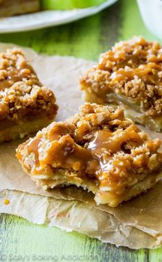 three pieces of apple pie sitting on top of a piece of parchment paper