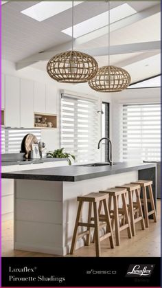 an image of a kitchen setting with bar stools in the foreground and window blinds in the background