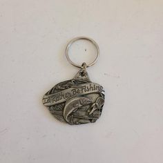 a metal keychain with a dolphin on it's side and the words oceanworld bobishing