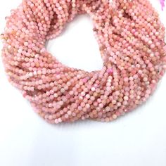 a pink beaded necklace on a white background